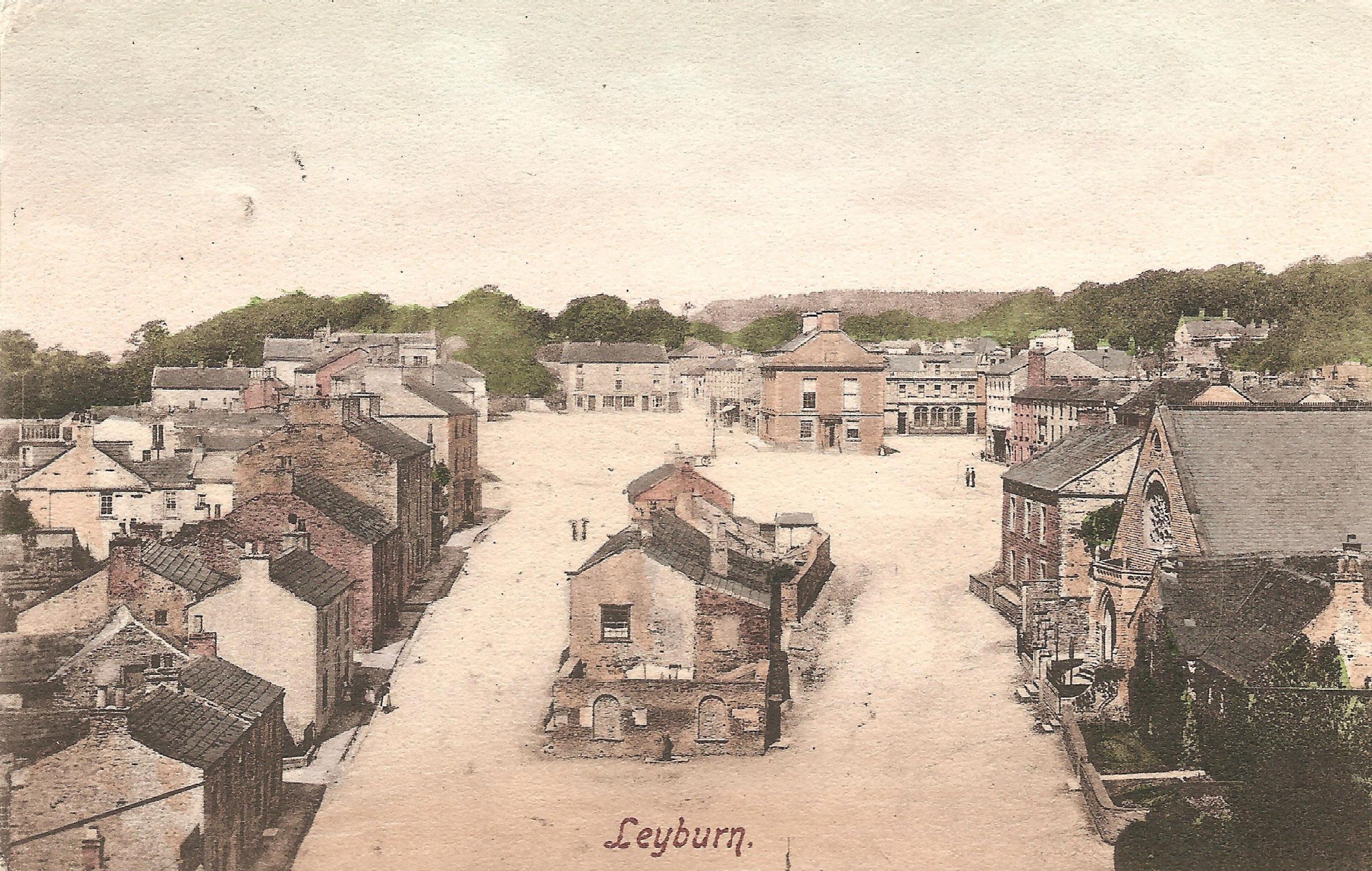 A 1906 postcard of a very empty Leyburn Market Place with the lions head fountain clearly visible as a white shape to the bottom right of the town hall