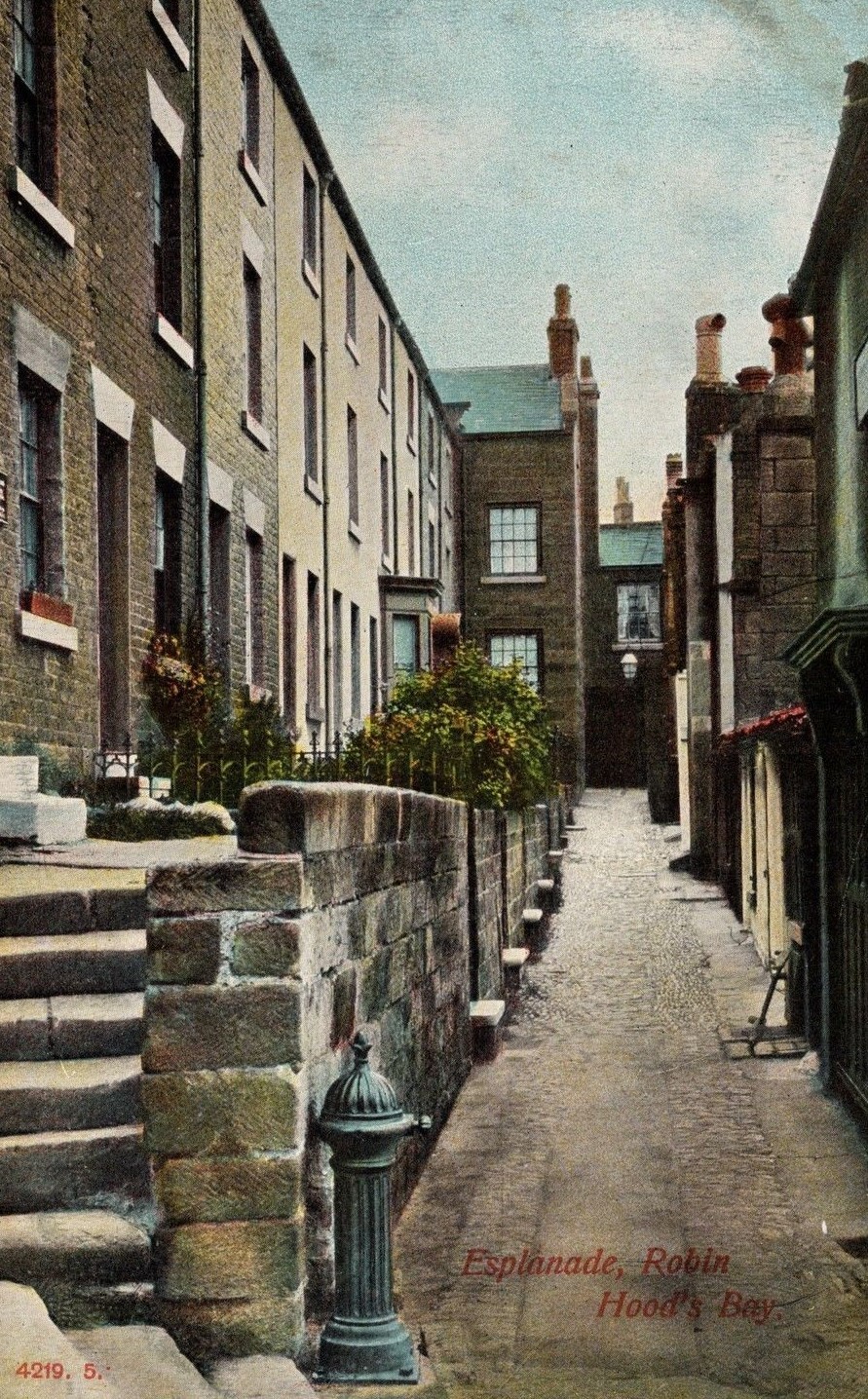 A postcard showing the original lions head fountain in Robin Hoods Bay