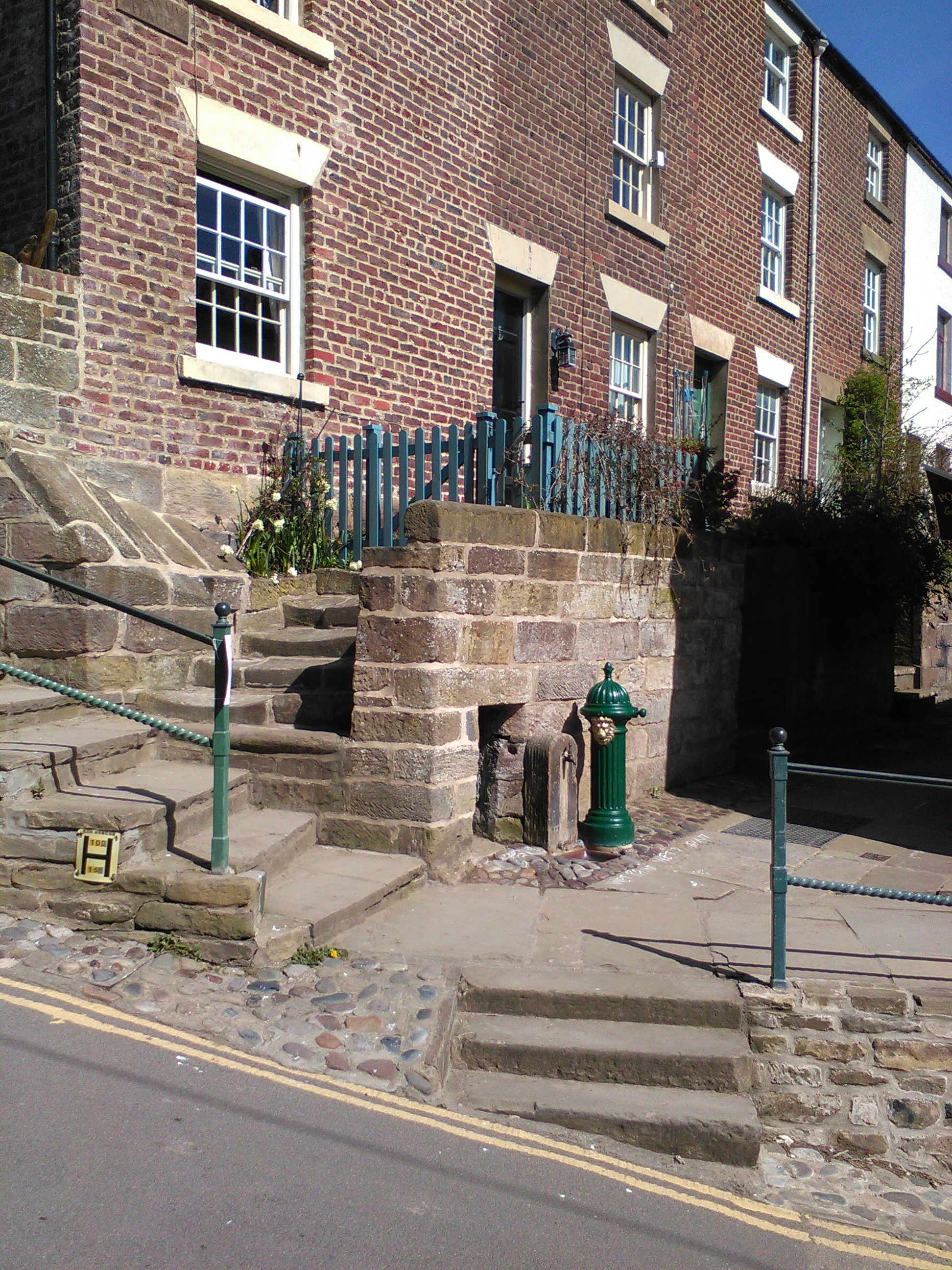 Geoff Fells replacement lions head fountain in Robin Hoods Bay